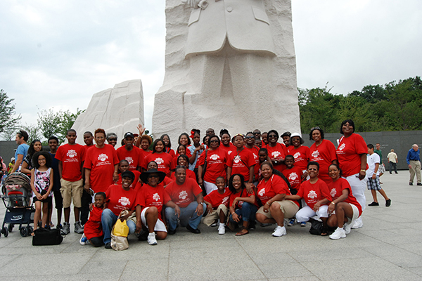 Group of people standing together in red shirts