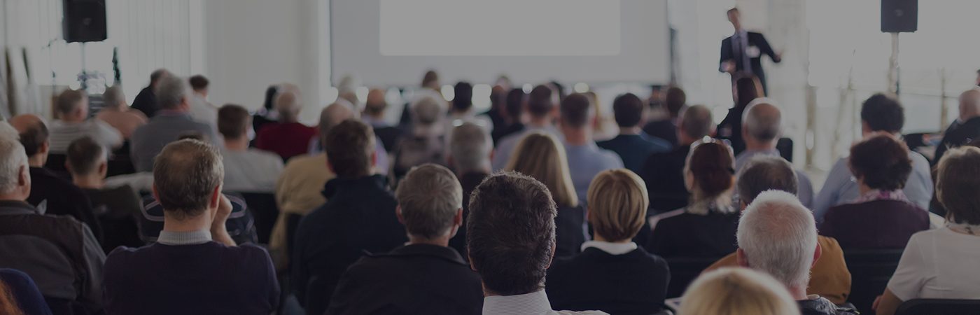 Back view of a room filled with people for meeting