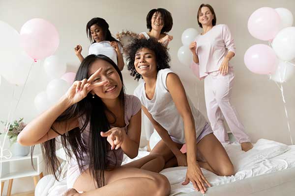 Group of ladies partying in a room with balloons