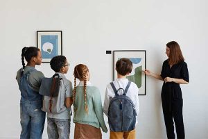 Person explaining the painting to children