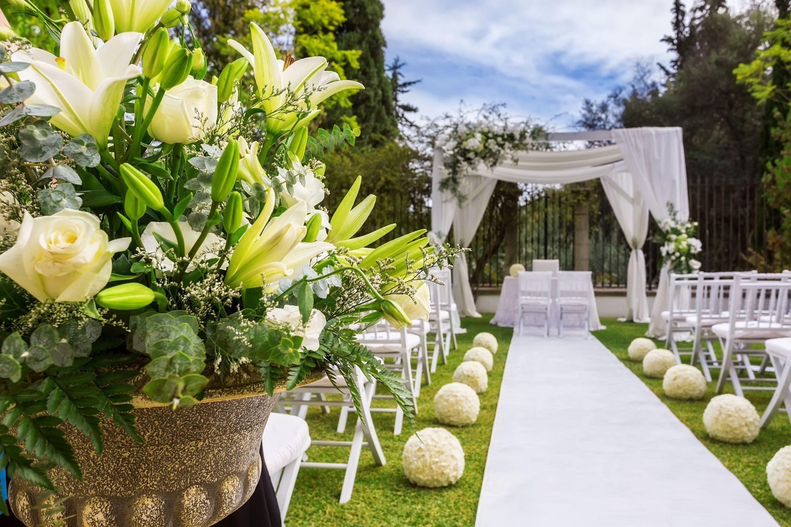 A wedding site decorated with flowers and some chairs