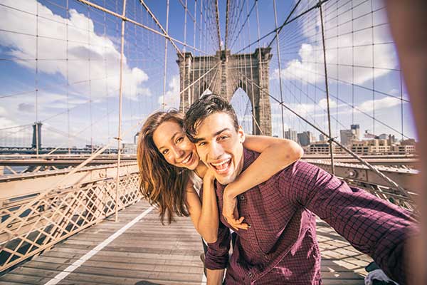 A couple taking selfie on a bridge